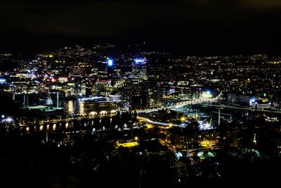 High angle view of illuminated city buildings at night