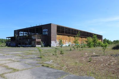 Abandoned building against clear blue sky