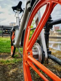 Close-up of bicycle wheel on field