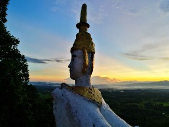 Close-up of statue against sky during sunset