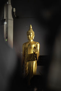 Golden buddha statue in sunlight