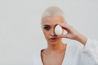 Portrait of beautiful young woman over white background