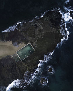 Aerial view of rock formation at sea