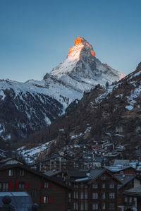 Scenic view of snowcapped mountains against clear blue sky