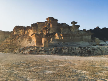 Low angle view of rock formation against sky