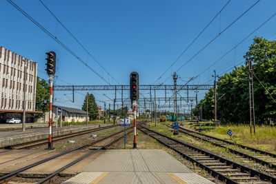 Railroad tracks against clear blue sky