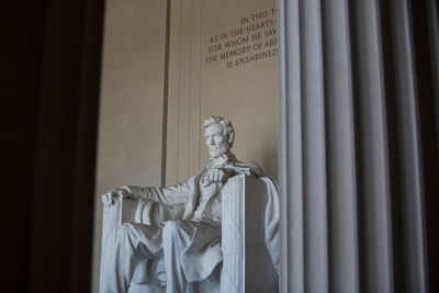 Low angle view of statue against wall