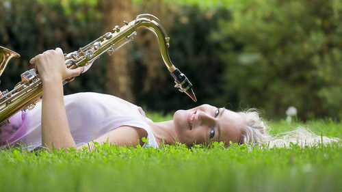 Low angle view of woman playing on field