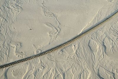 Close-up of rope on sand
