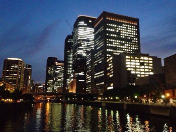 Reflection of buildings in water at night