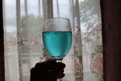 Close-up of woman holding glass of drink