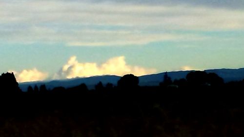 Scenic view of mountains against sky at sunset