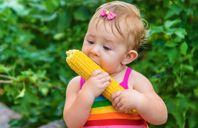 Cute girl eating corn