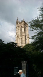 Low angle view of building against cloudy sky