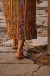 Low section of a woman standing barefeet