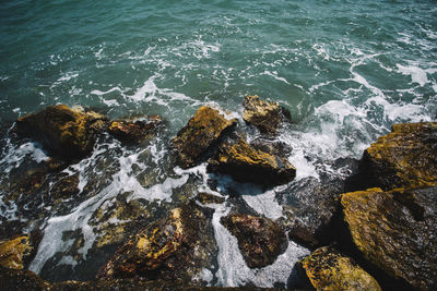 High angle view of rocks in sea