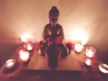 High angle view of lit candles on table