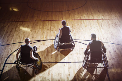 High angle view of men sitting on wheelchair in court