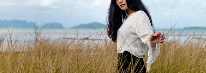 Young woman standing on field