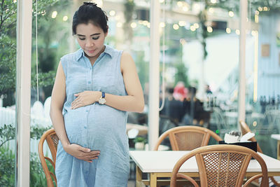 Young woman standing at cafe