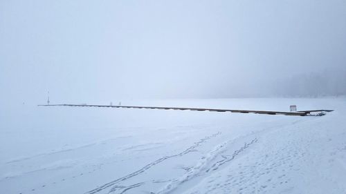 Snow covered land against sky