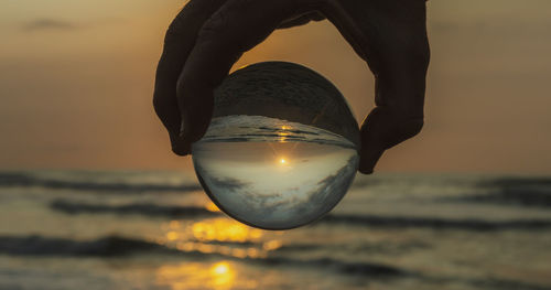 Sunset on the beach seen with crystal ball