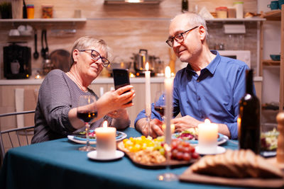 Portrait of smiling friends sitting at restaurant