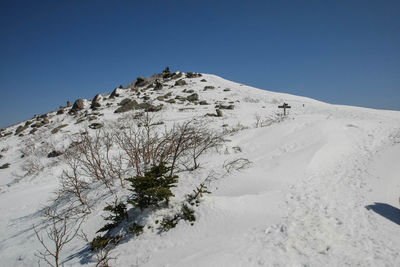 Scenic view of snowcapped mountains against clear blue sky