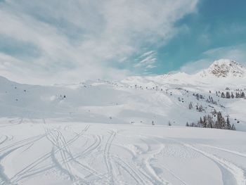 Scenic view of snow covered mountains against sky