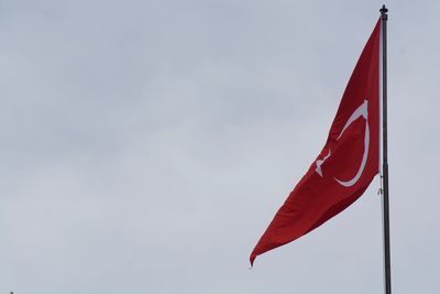 Low angle view of turkish flag against sky