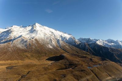 Scenic view of snowcapped mountains against clear sky