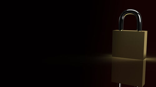 Close-up of padlocks against black background