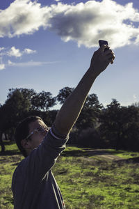 Man on tree against sky