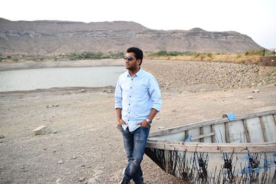 Full length of young man standing on mountain