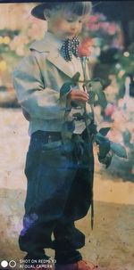 Full length of boy holding leaf