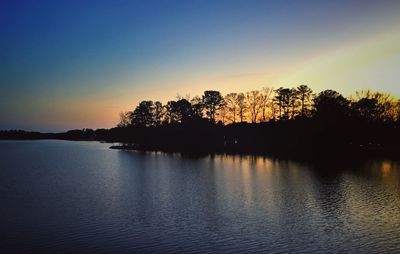 Scenic view of silhouette trees against sky during sunset