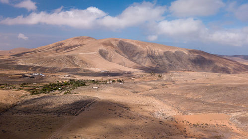 Scenic view of arid landscape against sky