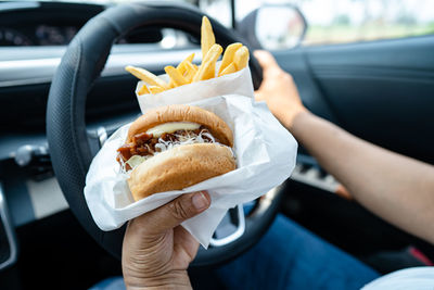 Cropped hand of woman holding food