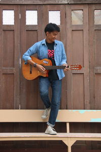 Full length of man playing guitar