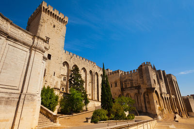 Low angle view of historic building against blue sky