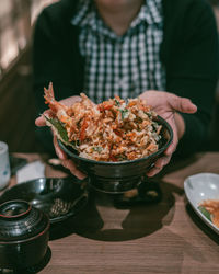 Midsection of man having food on table