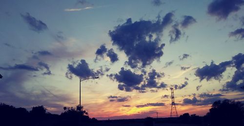 Low angle view of silhouette trees against sky during sunset