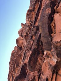 Low angle view of rock formation against sky