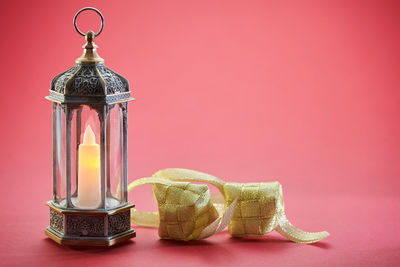 Close-up of illuminated electric lamp on table