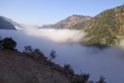Scenic view of trees and mountains against clear sky