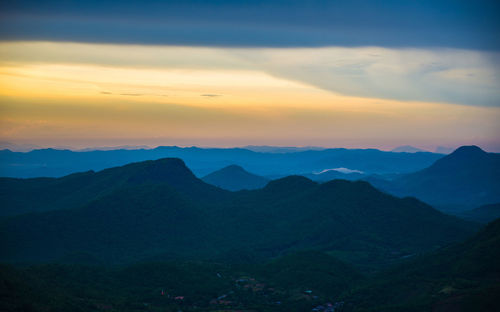 Scenic view of silhouette mountains against sky during sunset