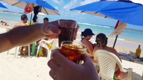 Group of people drinking glass on beach