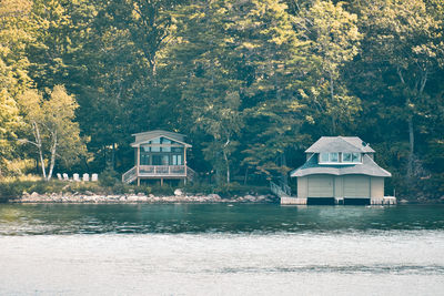 House by lake against building. 1000 islands. canada ontario