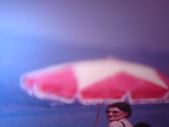 Portrait of woman in pink water against sky