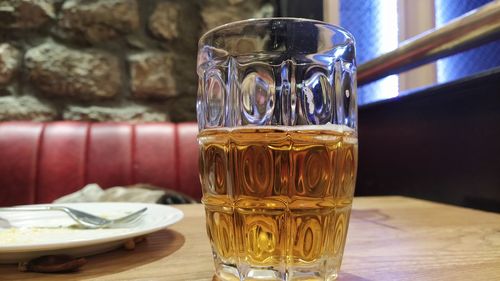 Close-up of beer glass on table